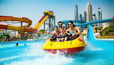 Families and friends enjoying rides and pools at a Dubai water park Families and friends enjoying rides and pools at a Dubai water park